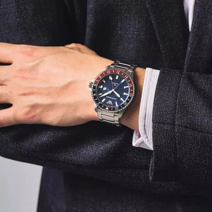 Emporio Armani AR11590 diver GMT watch worn on wrist showing dark blue dial and red/blue bezel