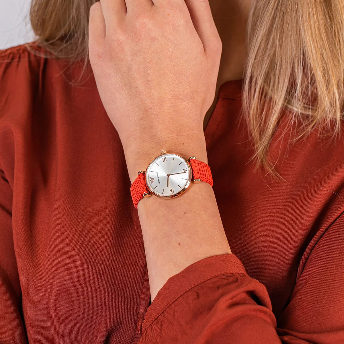 Emporio Armani AR1876 Gianni T-Bar rose gold women's watch worn on wrist with red leather strap
