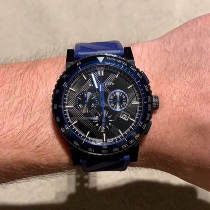 Burberry City Sport chronograph watch worn on wrist with blue rubber strap visible