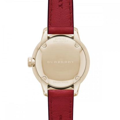 Burberry The Classic watch caseback showing gold-tone stainless steel case and burgundy leather strap