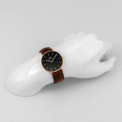 Daniel Wellington Bristol 40mm men's gold watch worn on wrist with brown leather strap