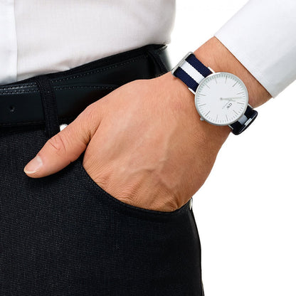 Daniel Wellington Glasgow silver watch on wrist showing white dial and navy striped strap detail
