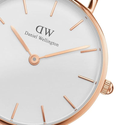 Close-up of white dial with rose gold bar indexes and Daniel Wellington branding