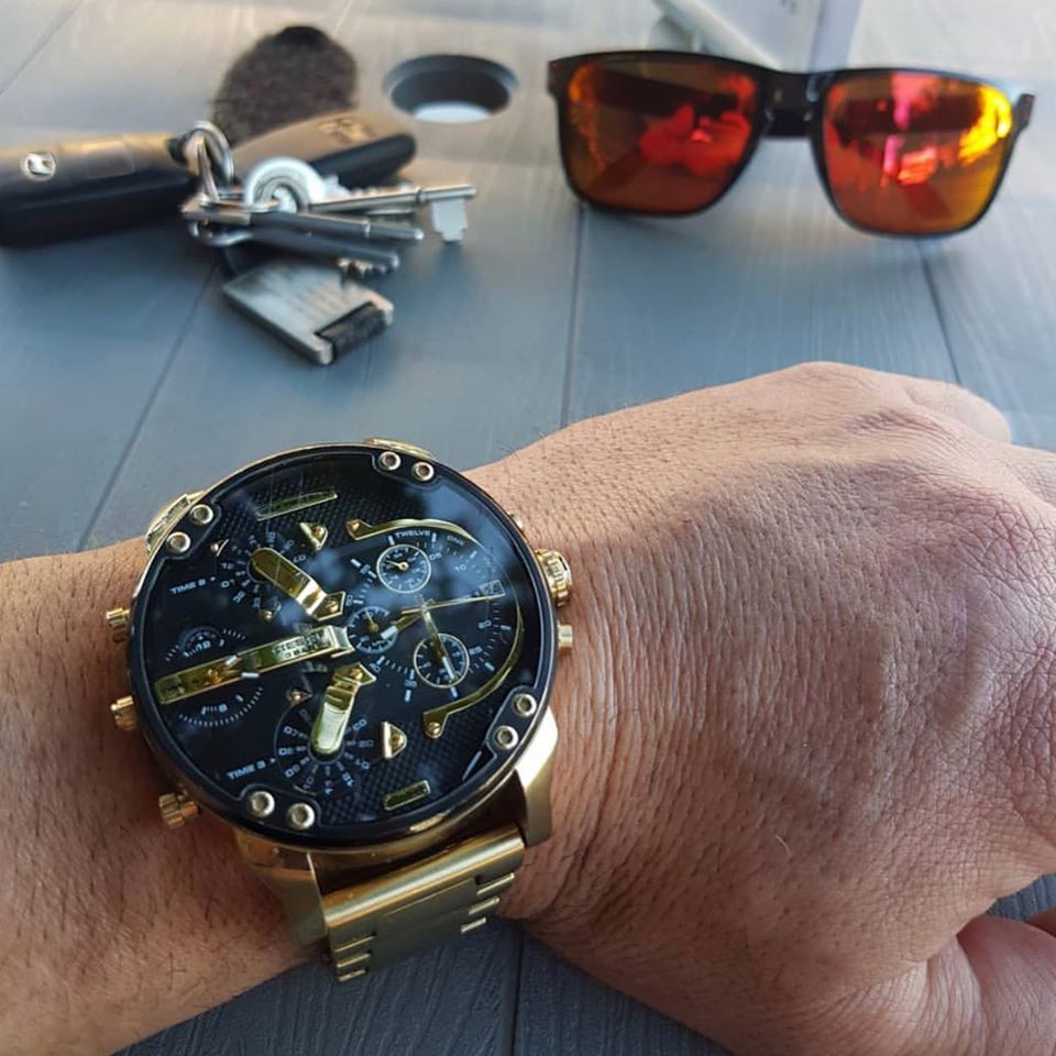 Diesel Mr. Daddy 2.0 on wrist with lifestyle accessories, gold and black chronograph timepiece