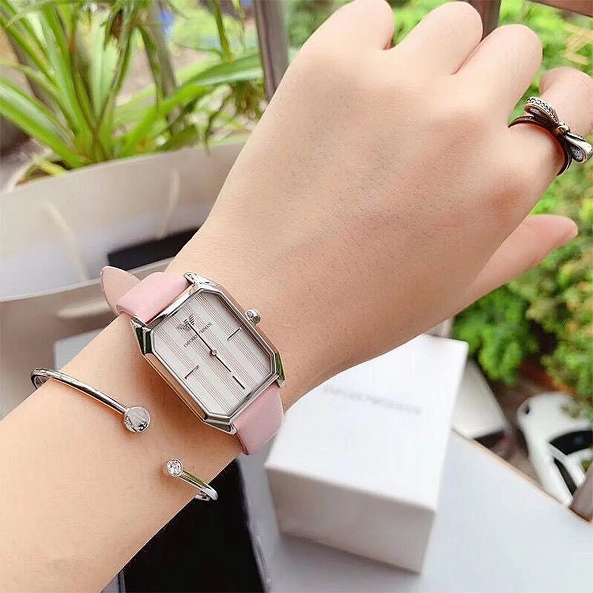 AR11207 worn on wrist with accessories, displaying rectangular case design