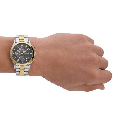 AR11527 chronograph watch worn on wrist showing two-tone bracelet and dark dial