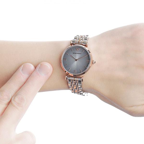 AR1725 grey dial watch worn on wrist with two-tone rose gold and silver bracelet