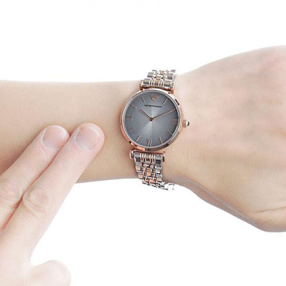 AR1725 grey dial watch worn on wrist with two-tone rose gold and silver bracelet