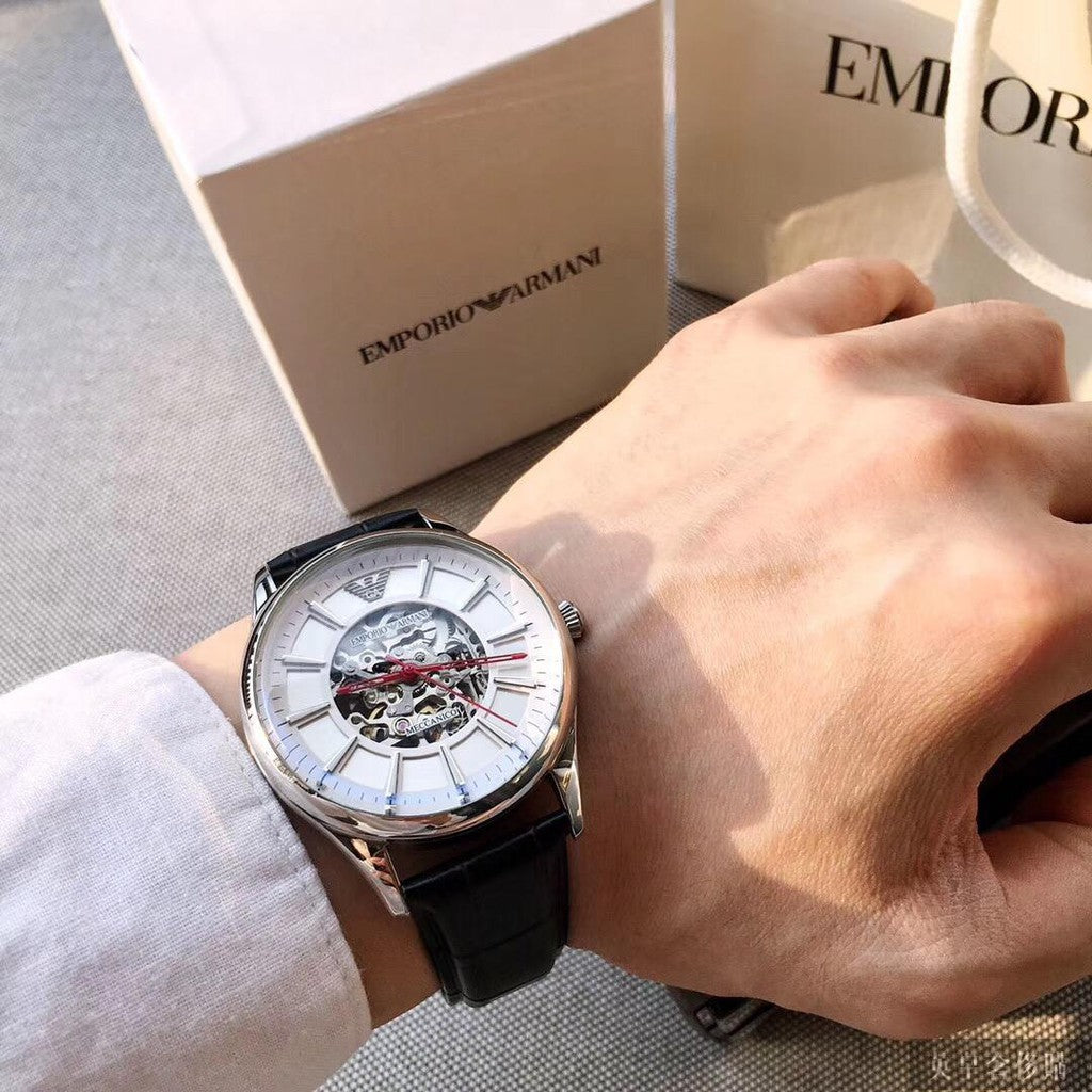 Emporio Armani automatic skeleton watch on wrist with branded packaging box visible