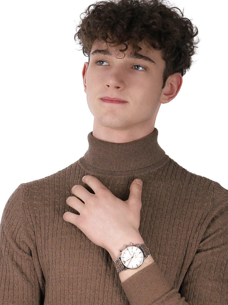 Emporio Armani Gianni XL two-tone chronograph watch worn on wrist against brown turtleneck