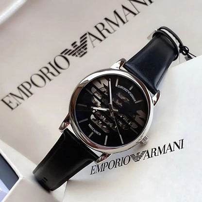 Emporio Armani Meccanico watch displayed at angle with Emporio Armani box packaging