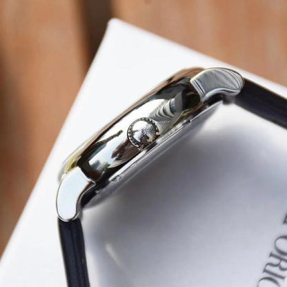 Watch side profile showing stainless steel case and crown with black leather strap