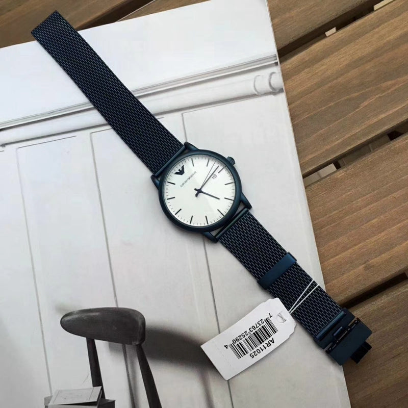 Emporio Armani Luigi watch laying flat showing white dial and blue mesh strap