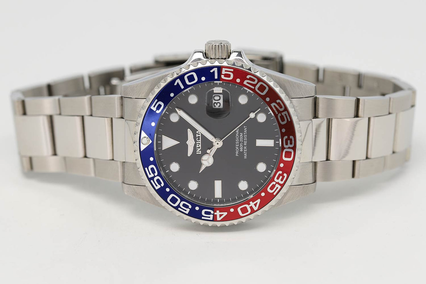 Invicta Pro Diver watch angled view showing steel bracelet and Pepsi bezel