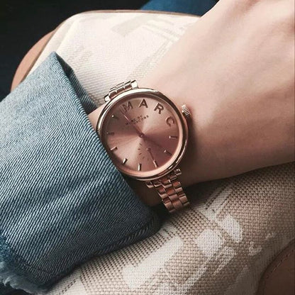 Marc Jacobs Sally rose gold watch MBM3364 on wrist with blue sleeve