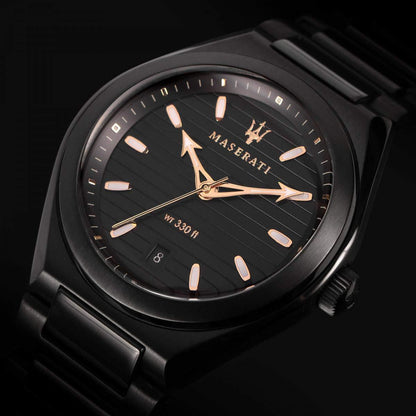 Close-up of black dial showing Maserati branding, gold hands, and water resistance marking