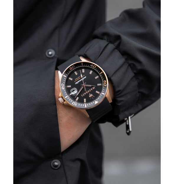 Maserati Sfida watch on wrist with black rubber strap and rose gold case visible