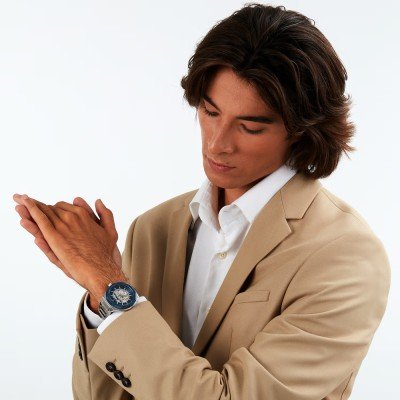 Maserati Stile skeleton watch worn on wrist with beige blazer and white shirt