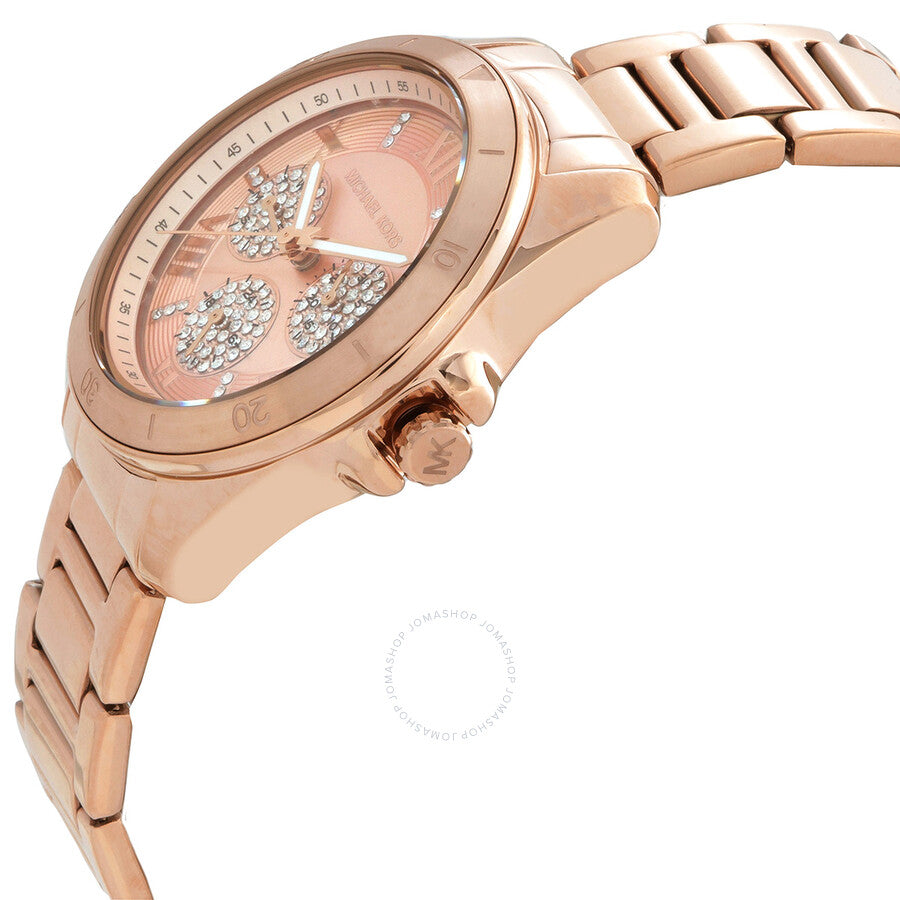 Michael Kors Alek watch at angle showing rose gold case, dial detail with crystal subdials, and link bracelet