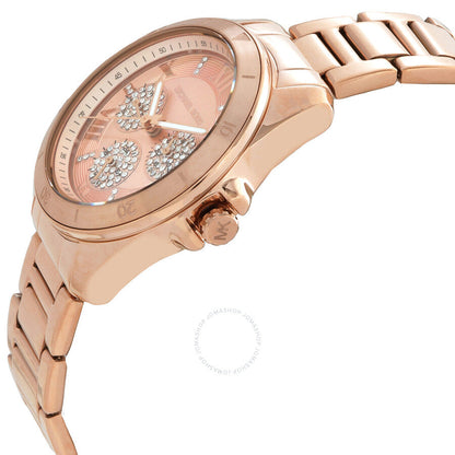 Michael Kors Alek watch at angle showing rose gold case, dial detail with crystal subdials, and link bracelet