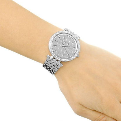 Michael Kors Darci silver-tone watch worn on wrist with crystal pave bezel