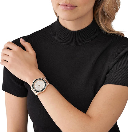 Michael Kors Everest rose gold pavé watch worn on wrist with black strap