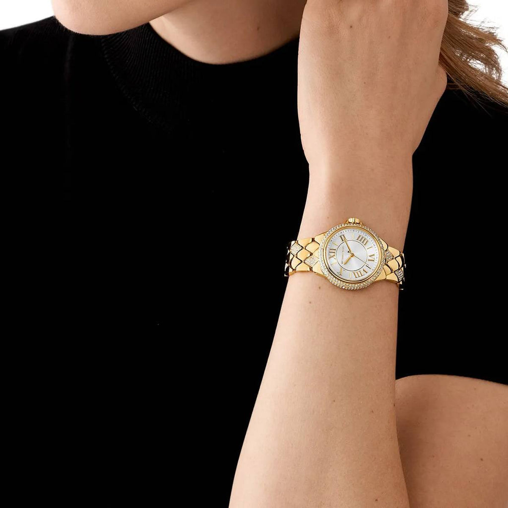 Michael Kors Mini Camille MK4801 gold-tone women's watch worn on wrist, showing white dial and quilted bracelet