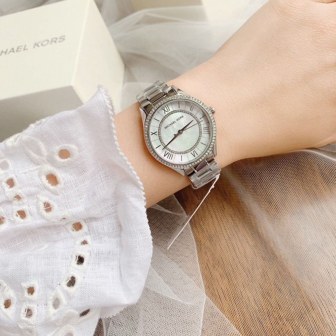 Michael Kors Lauryn watch worn on wrist with silver-tone bracelet