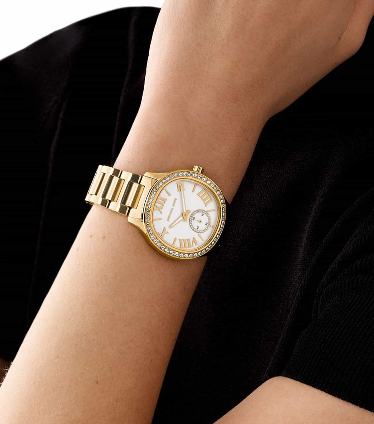 Michael Kors Sage Pavé women's watch worn on wrist with gold-tone bracelet