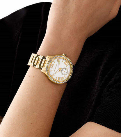 Michael Kors Sage Pavé women's watch worn on wrist with gold-tone bracelet
