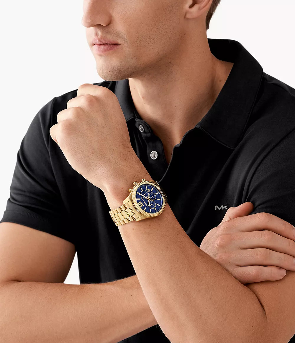 Michael Kors MK9153 gold watch worn on wrist with navy blue dial visible