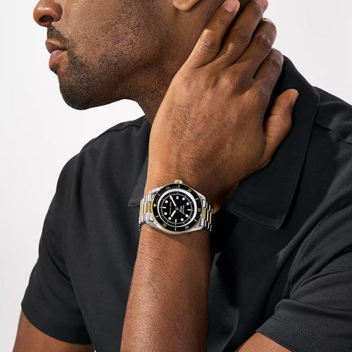 Michael Kors MK9180 two-tone men's watch worn on wrist with black dial