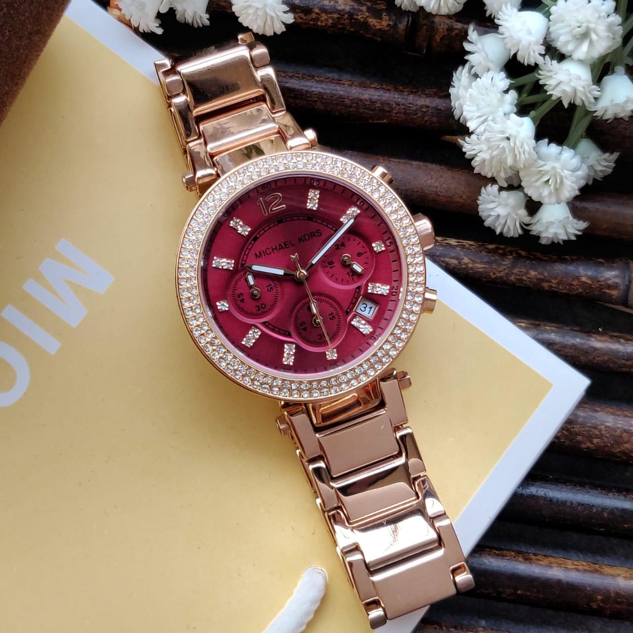 Michael Kors Parker watch from angled view with rose gold-tone bracelet and red dial