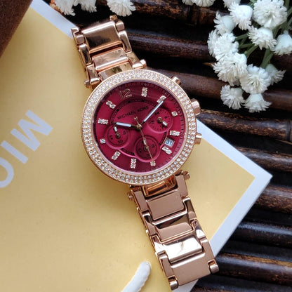 Michael Kors Parker watch from angled view with rose gold-tone bracelet and red dial