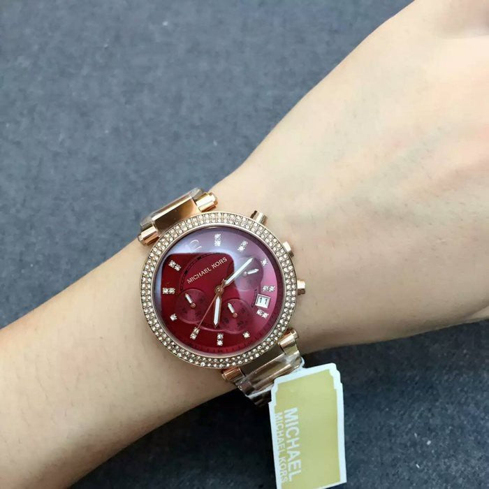 Michael Kors Parker chronograph watch worn on wrist with red dial and diamond bezel
