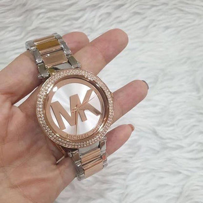 Michael Kors Parker MK6314 watch held in hand showing rose gold and silver bracelet details