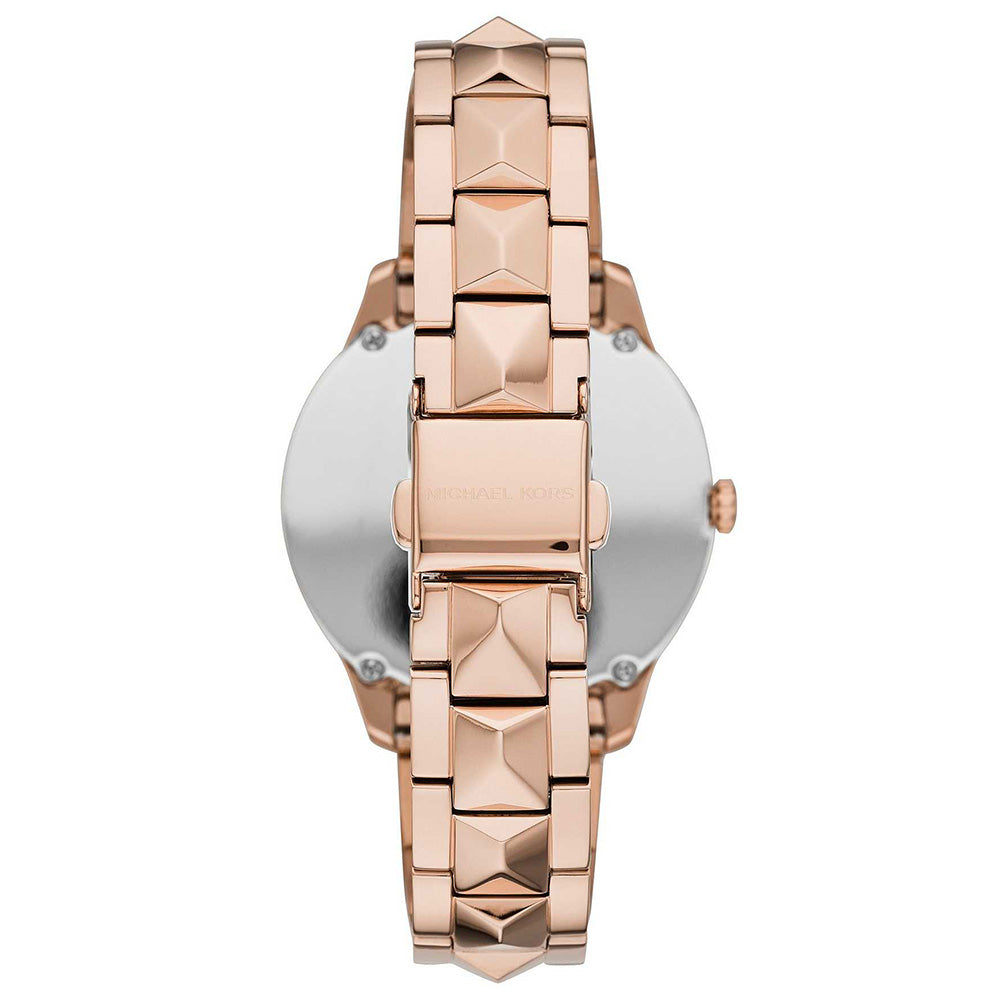 Back view of Michael Kors Runway Mercer watch with caseback and rose gold pyramid stud bracelet