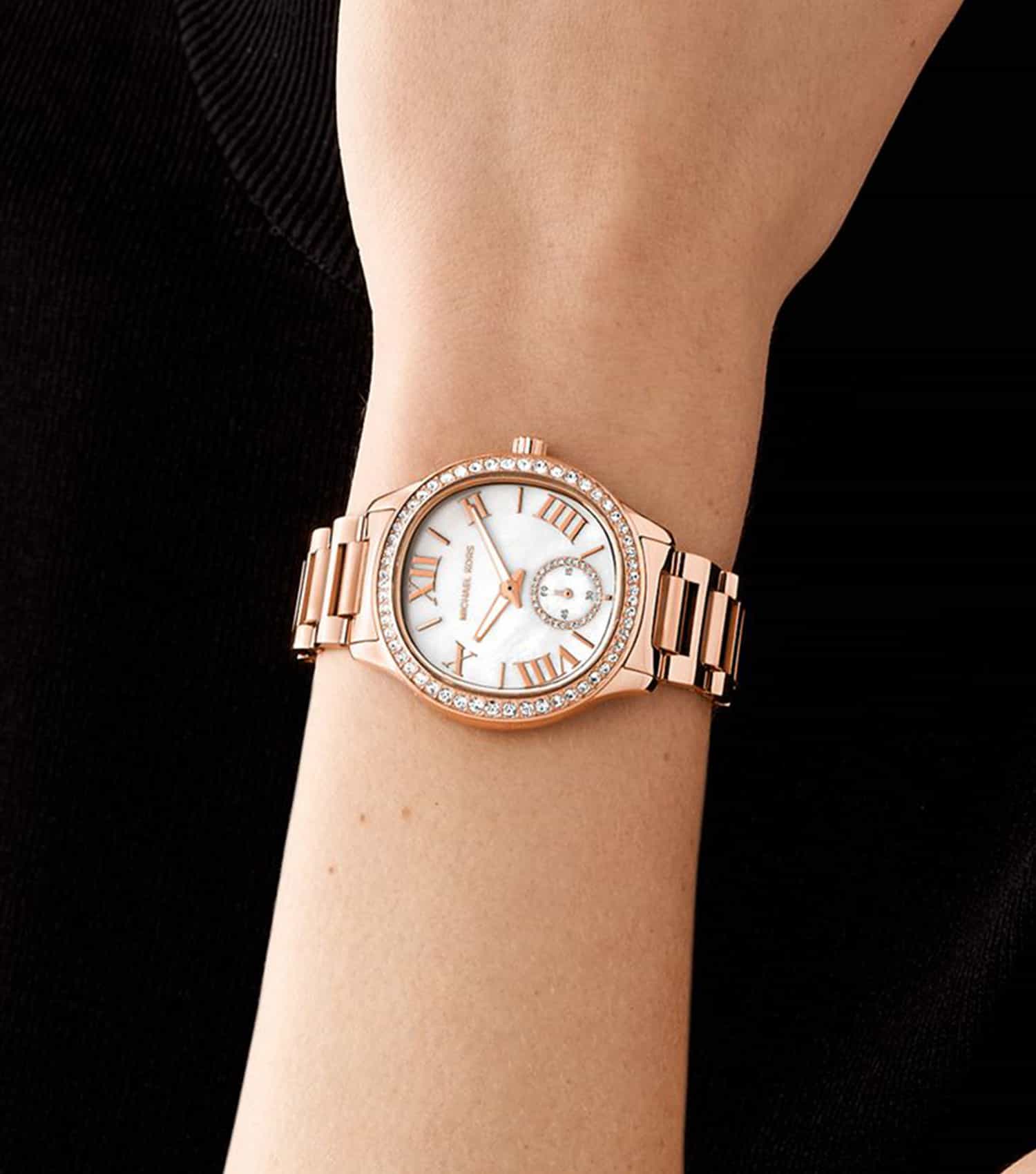 Michael Kors Sage MK4806 rose gold watch worn on wrist with white dial and crystal bezel