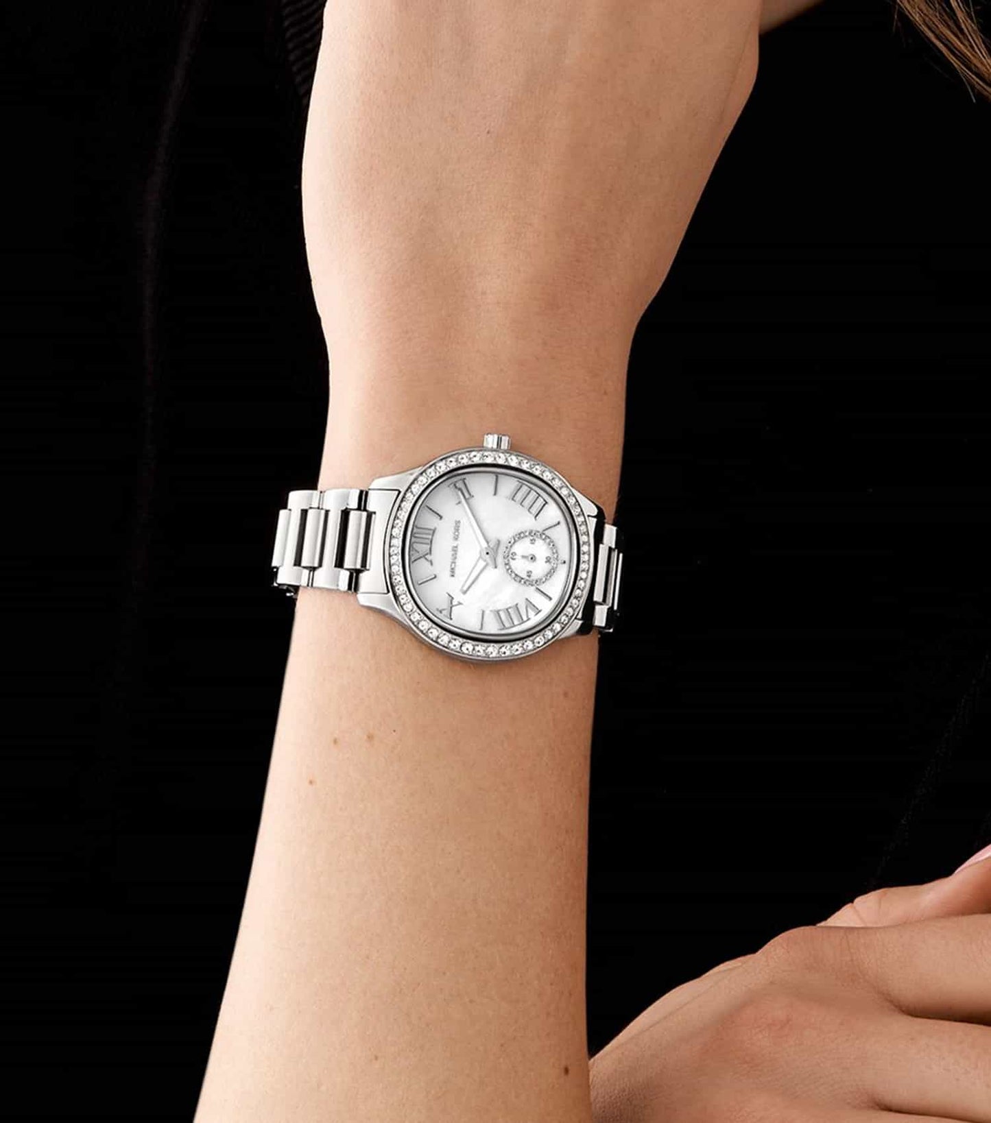 Michael Kors Sage watch worn on wrist, showing white dial and silver-tone bracelet