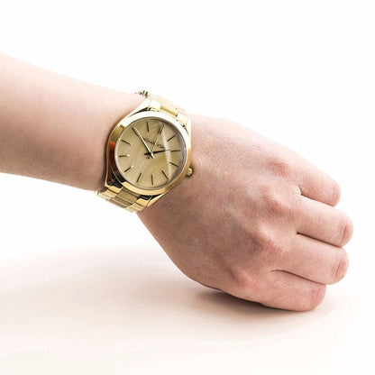 Michael Kors Slim Runway gold-tone watch worn on wrist