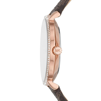 Side profile of Michael Kors Pyper watch showing rose gold case, crystal-set bezel, and brown leather strap