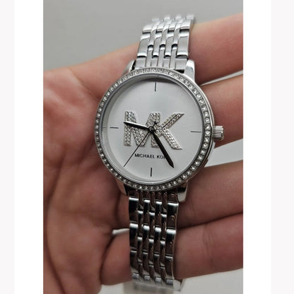 Michael Kors St. Moritz women's watch worn on wrist showing silver-tone bracelet and dial