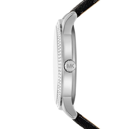 Side view of Michael Kors Tibby watch showing silver case profile with crystal-set bezel and black leather strap
