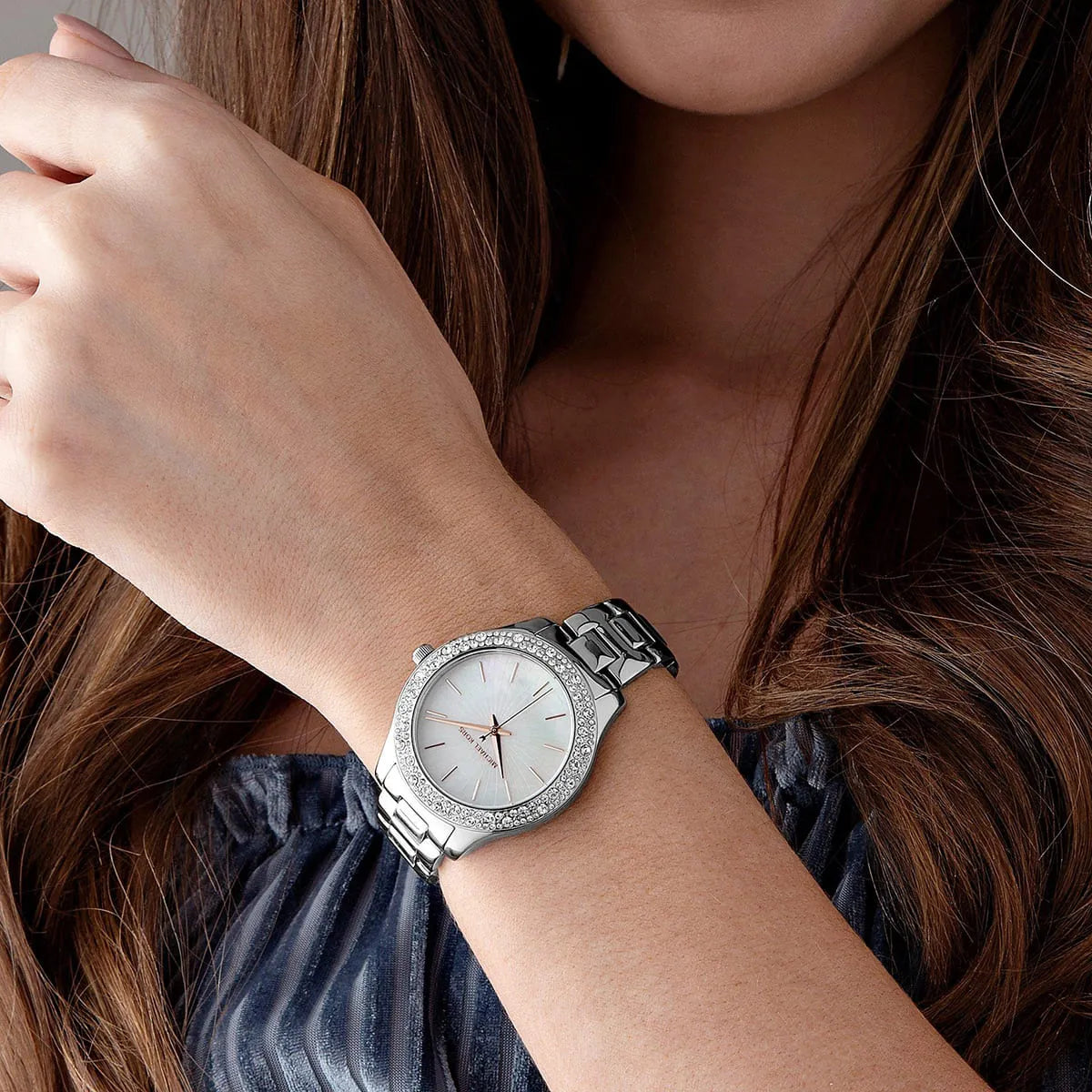 Michael Kors Liliane watch worn on wrist showing white dial and silver metal bracelet