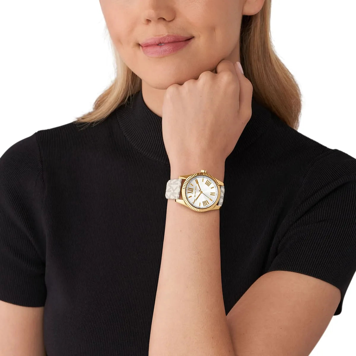 Michael Kors Lexington watch worn on wrist with white dial, gold-tone case, and grey patterned leather strap