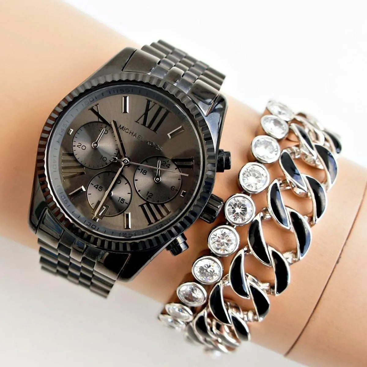 Michael Kors Lexington chronograph watch worn on wrist with stainless steel bracelet