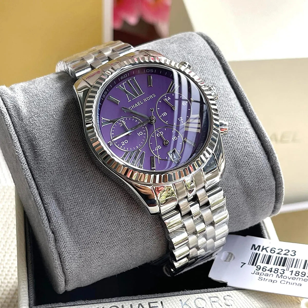Michael Kors Lexington MK6223 chronograph watch displayed on gray wrist rest pillow