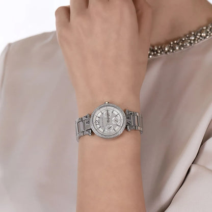Michael Kors Parker Mini multifunction watch worn on wrist with stainless steel bracelet