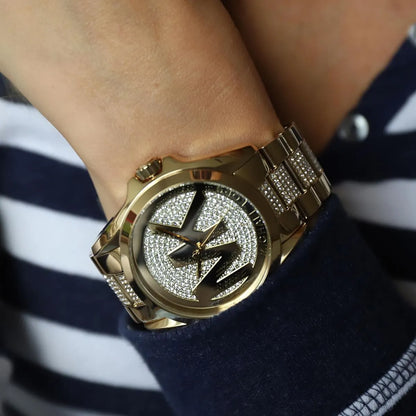 Michael Kors Bradshaw gold watch worn on wrist with crystal-paved dial
