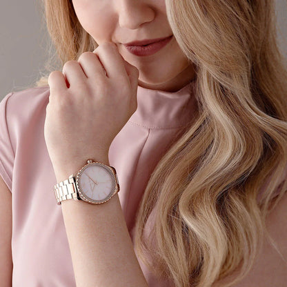 Michael Kors Layton watch worn on wrist showing pink dial and rose gold bracelet styling
